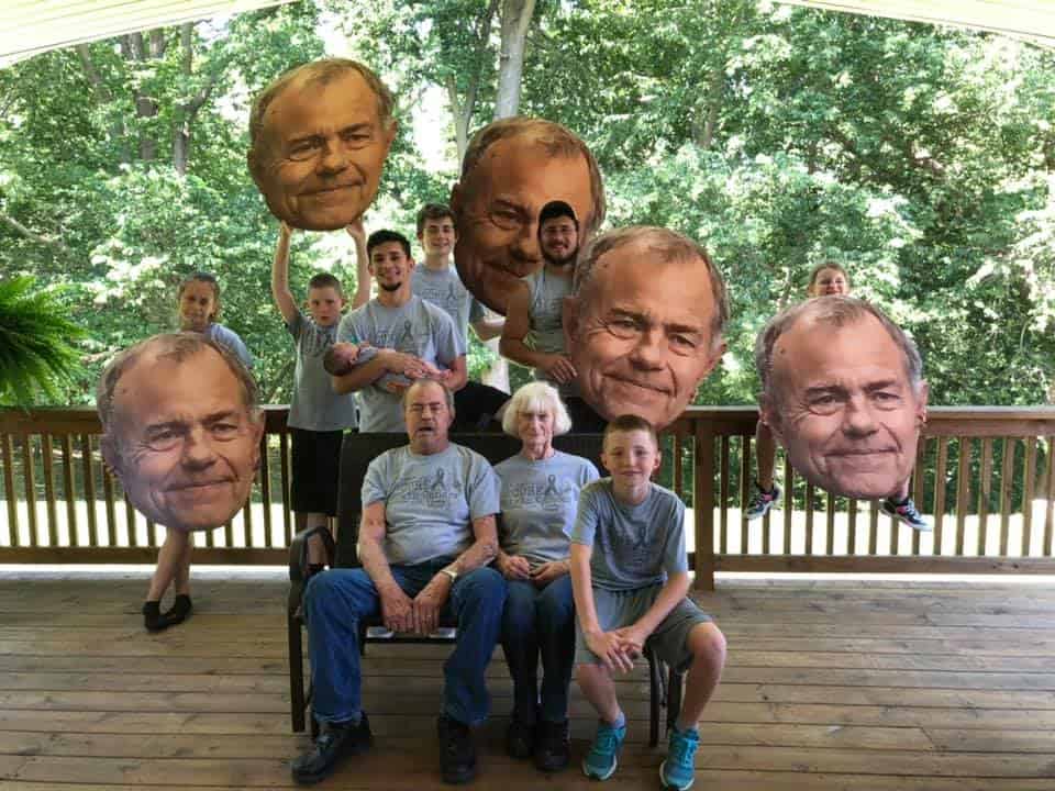 Family showing off multiple BigHeads of father.