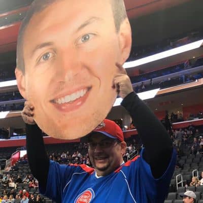 Fan at a Detroit Pistons game holding a BigHead.