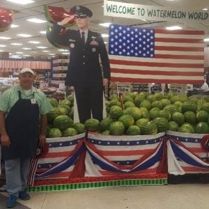 POS standee in a grocery store of a military member saluting