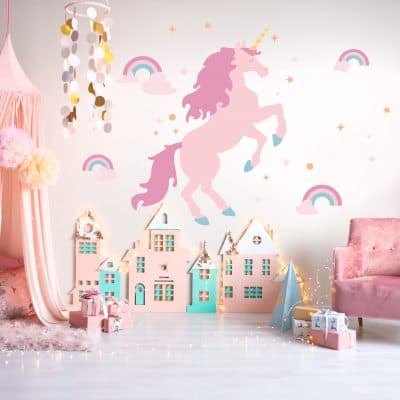 Unicorn wall decal in front of play house in child's play room.