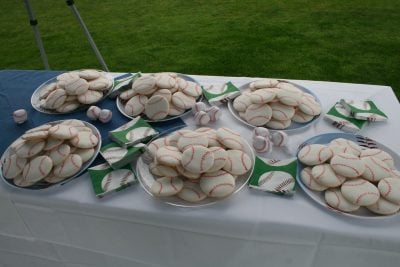 Baseball cookies, plates, and napkins at a baseball themed party.