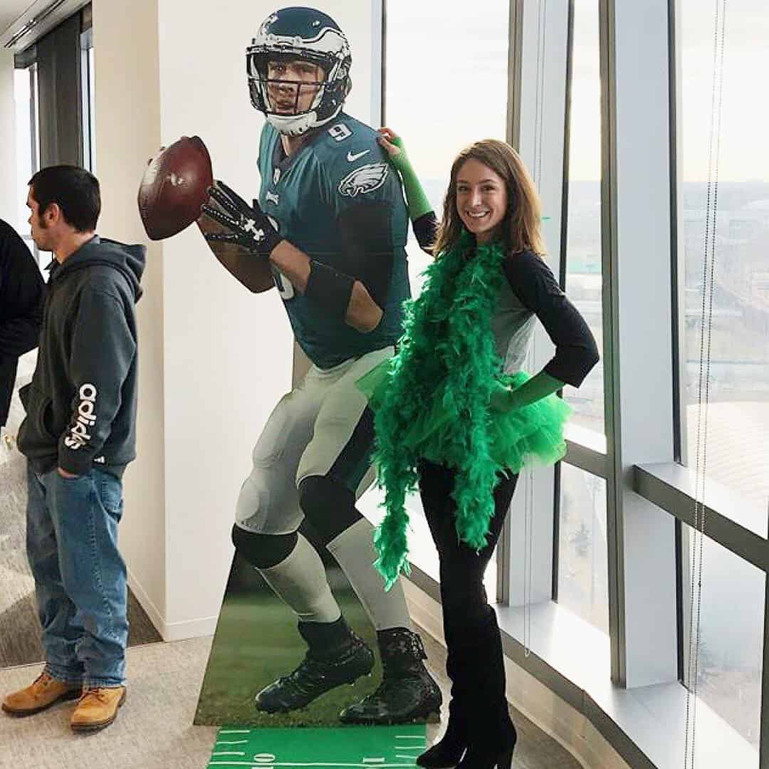 Football player standee at party.