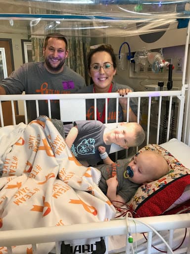 Jake with cutout of brother Max and family in hospital room.