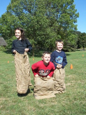 Three children potato sack race.