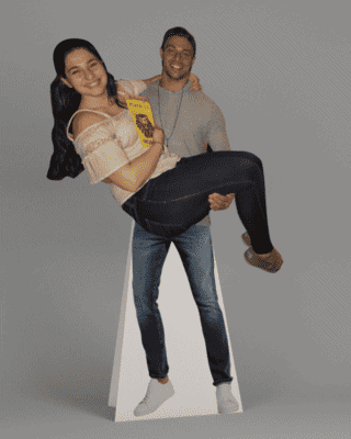 Man and woman cardboard cutouts together.