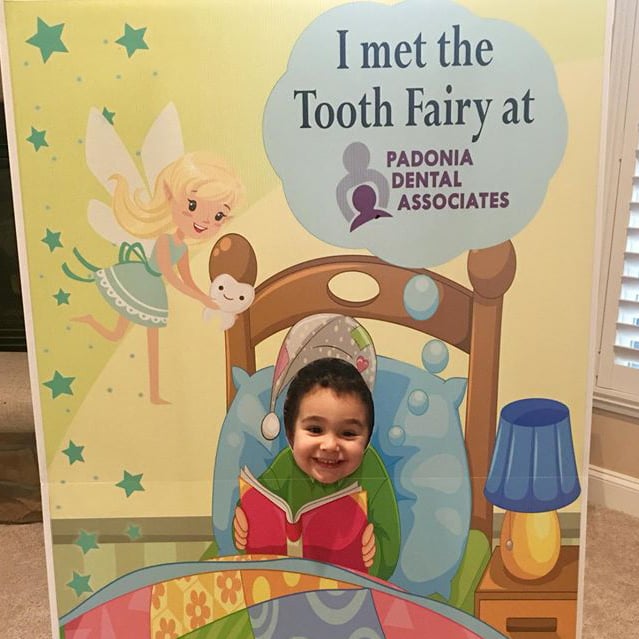 A cardboard face cutout display for a for children and pictures.