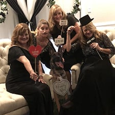 A dog cutout used as a photo booth prop at a wedding.